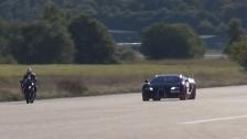 BMW S1000RR wheelie next to Bugatti Veyron Vitesse 1200 HP